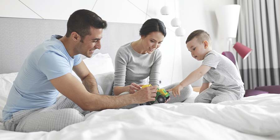 Family playing in bedroom