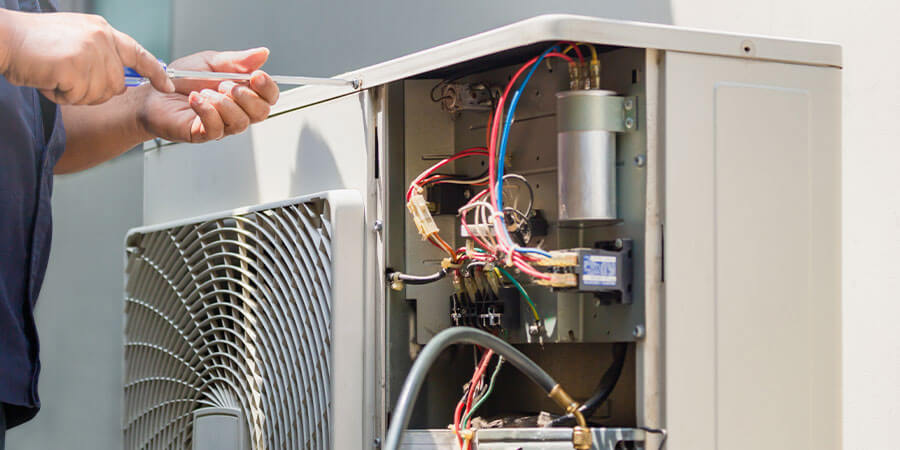 Service technician checking ductless unit